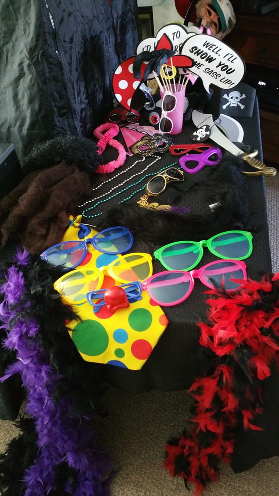 The Frame Us Photo prop box: signs, glasses, hats and other props laid out for guests.